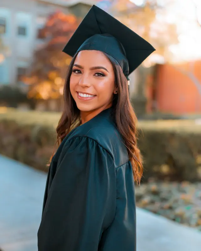 Smiling graduate wearing a cap and gown